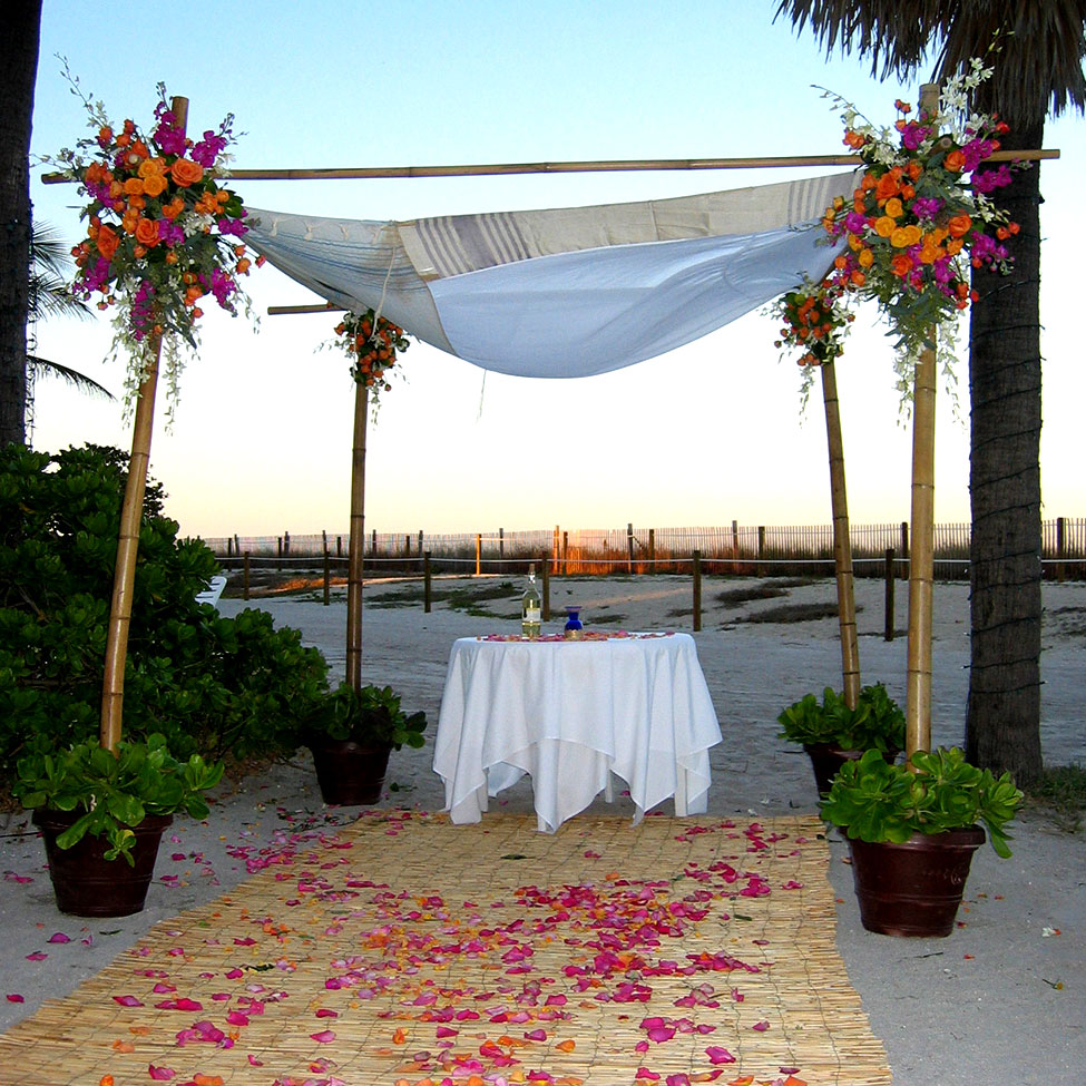 Jewish wedding chuppa at sunset on the beach.